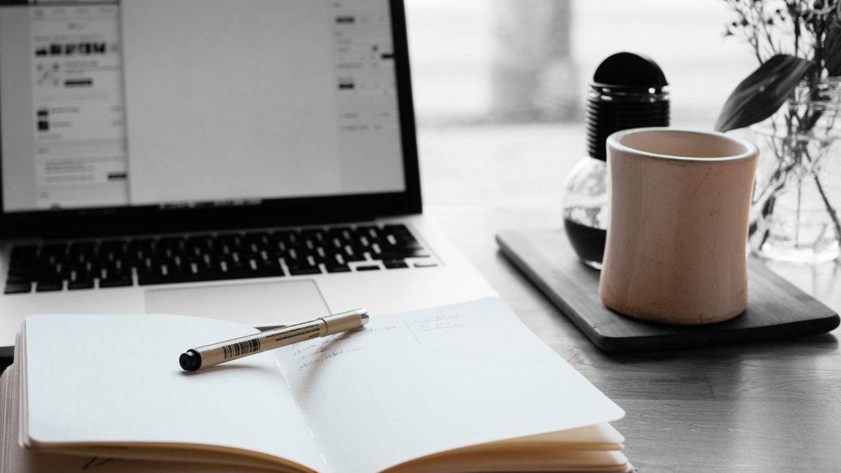 journal and mug of coffee